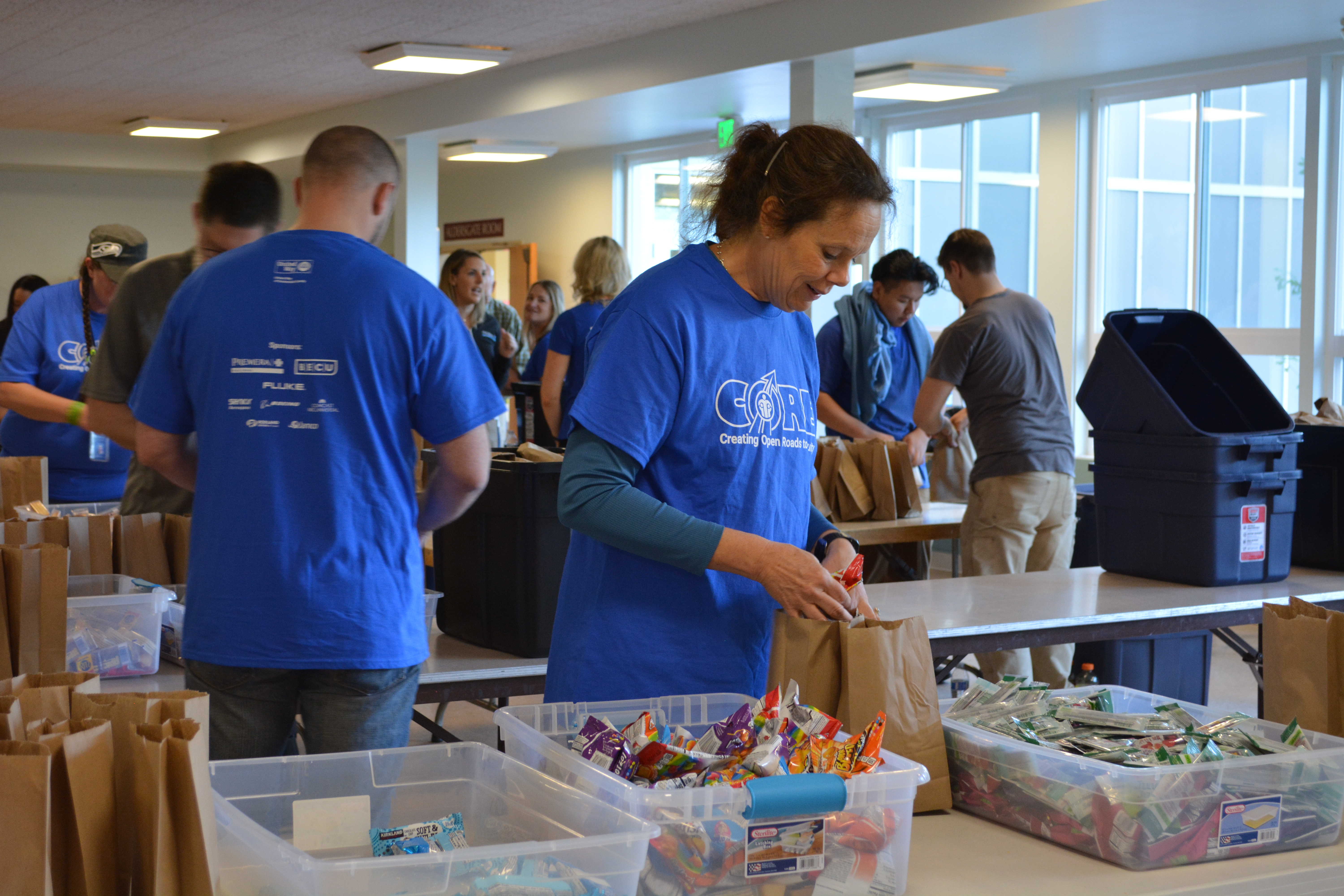 Volunteers packing snack kits for Washington Kids in Transition