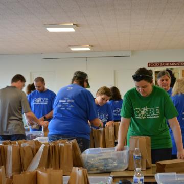 Volunteers packing snack kits for Washington Kids in Transition